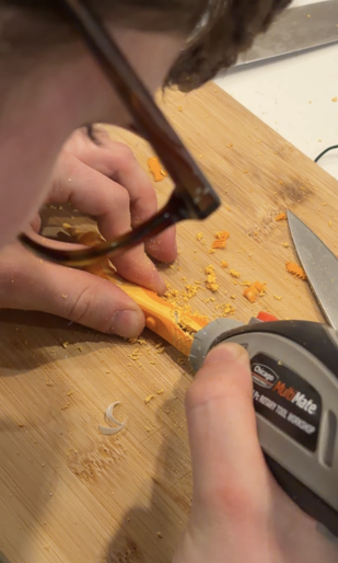 Close-up of hands working on CaniBrush prototype components